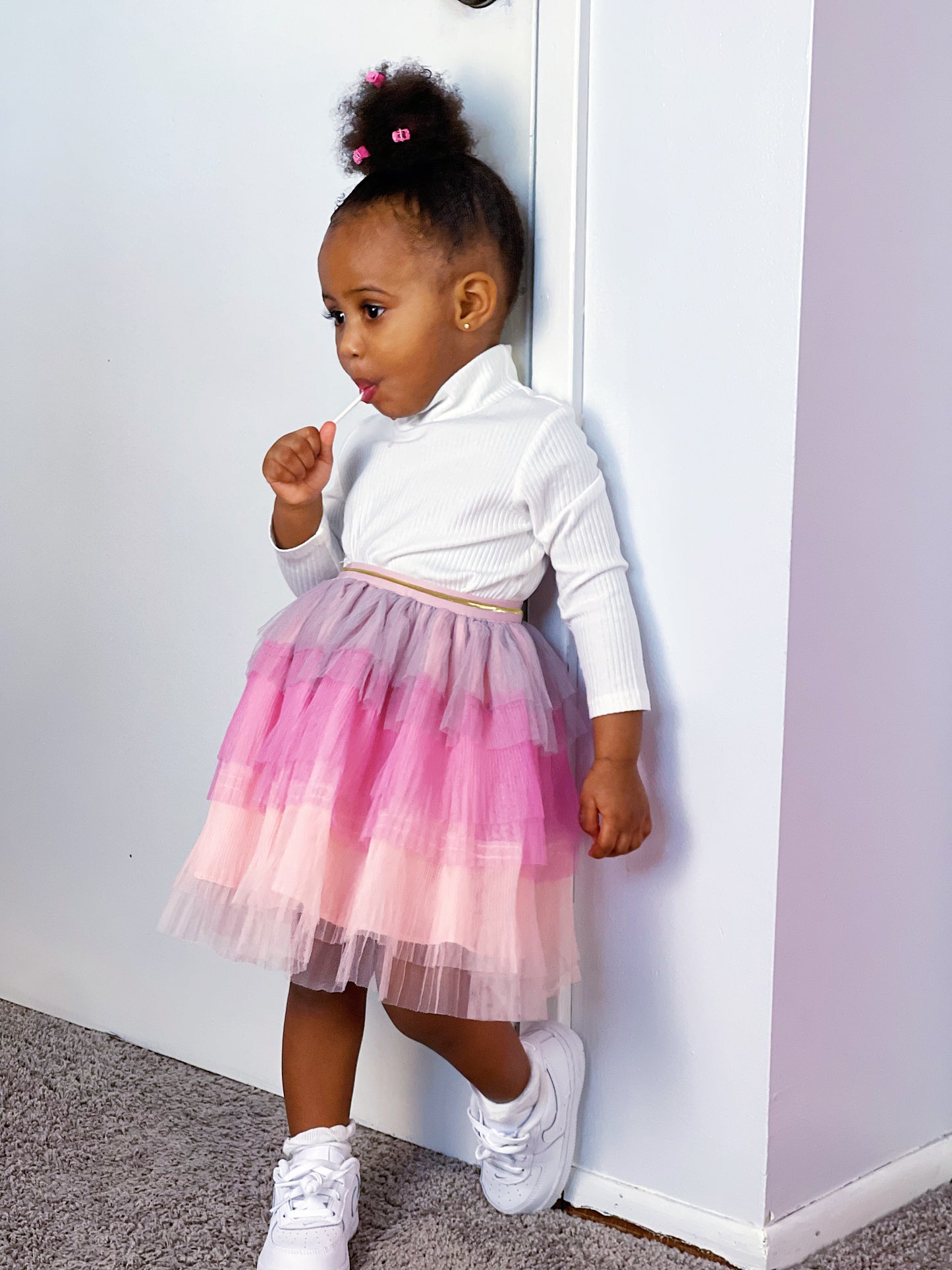Cute Little Girl In Tutu Skirt Looking At The Camera